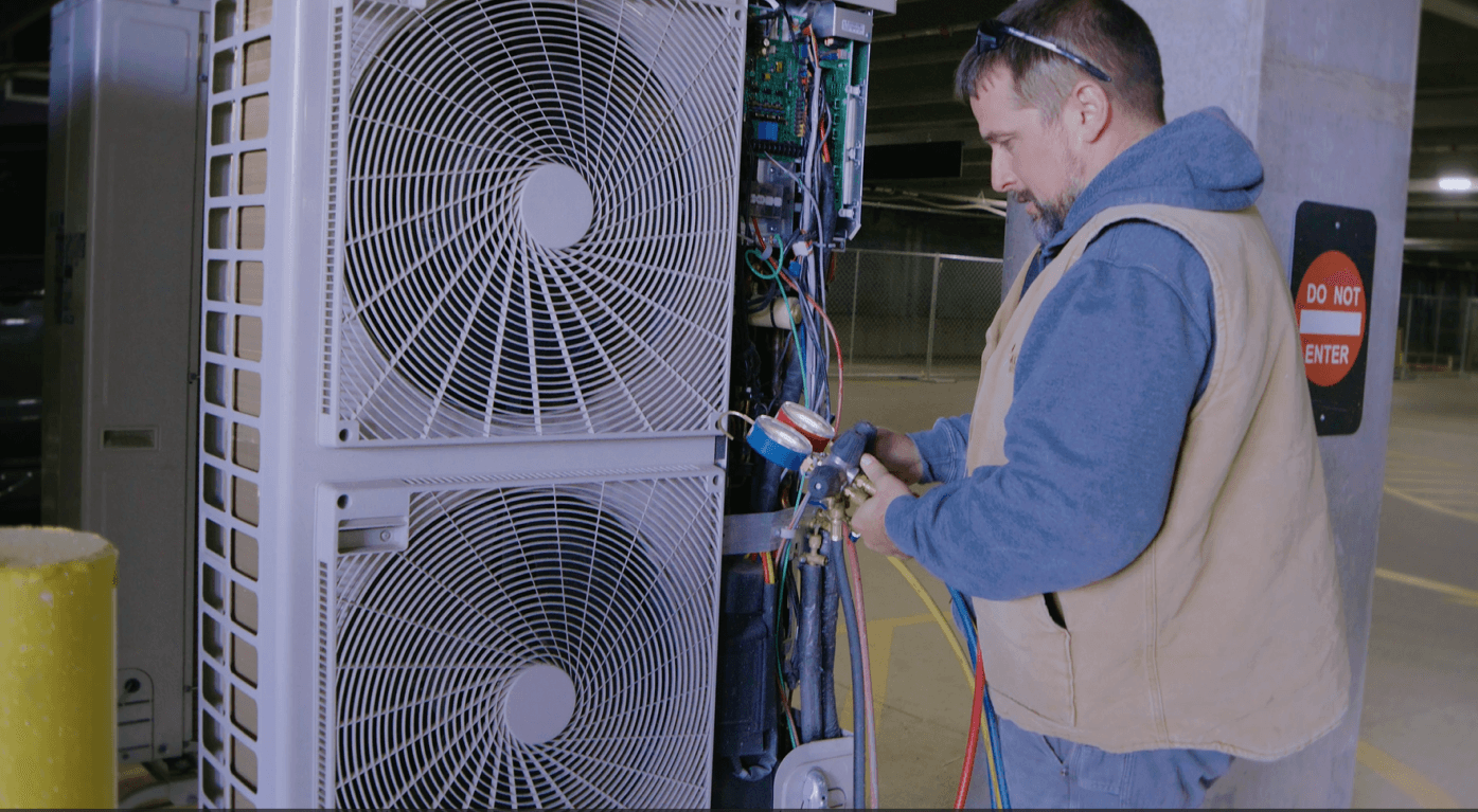 Climate Systems employee performing HVAC repairs